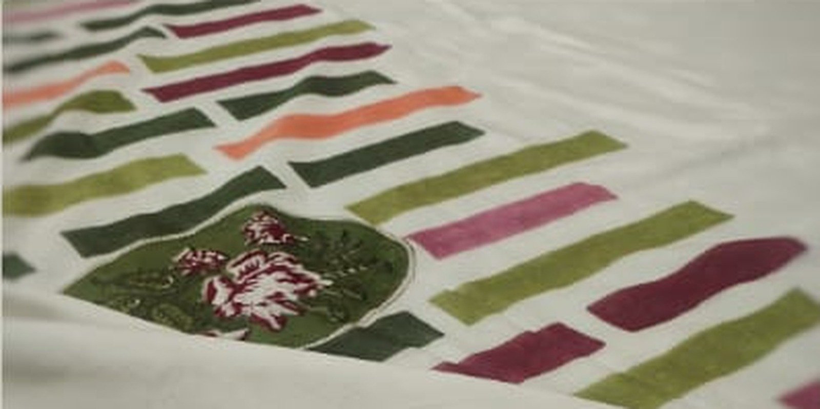 Hand-printed textile with layered geometry and botanical detail